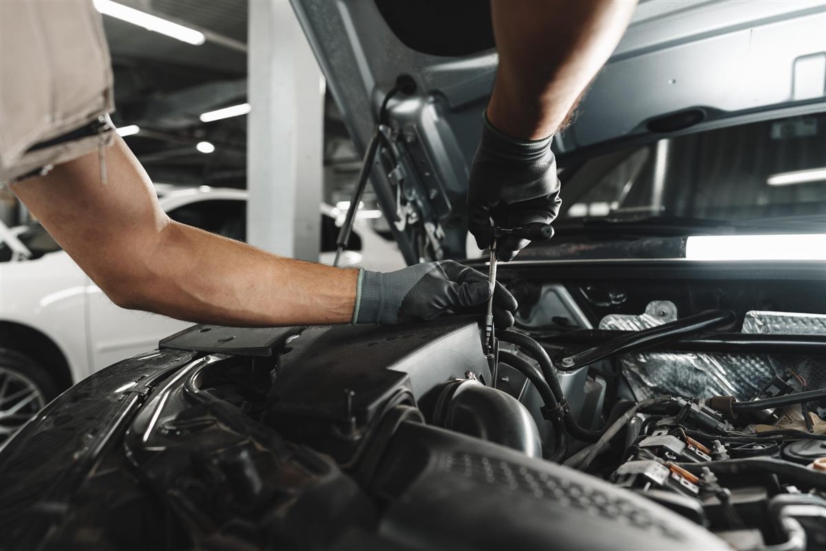 Mechanic working under the hood of a car