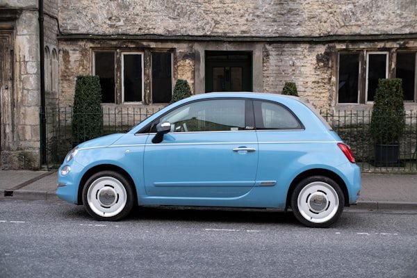 Light blue compact car parked on a street